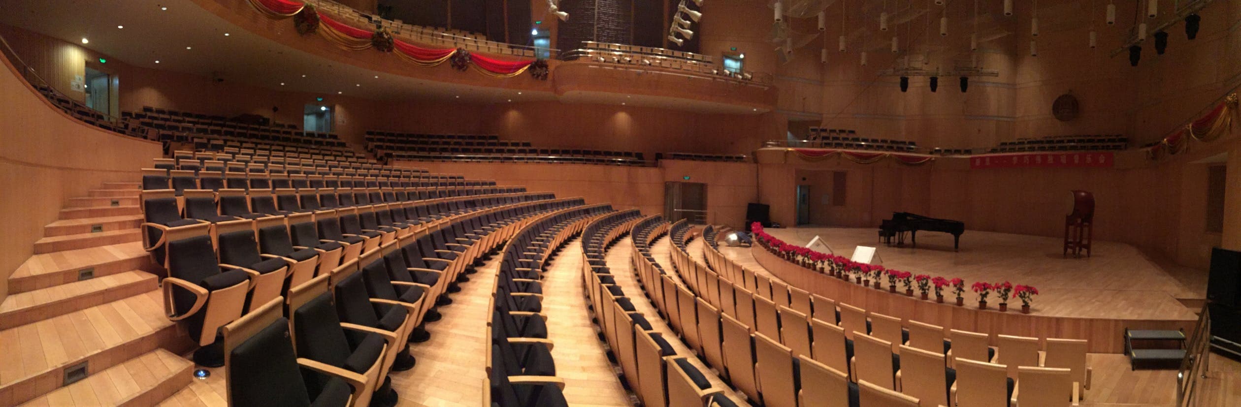 A grand piano in a bright, protected indoor space